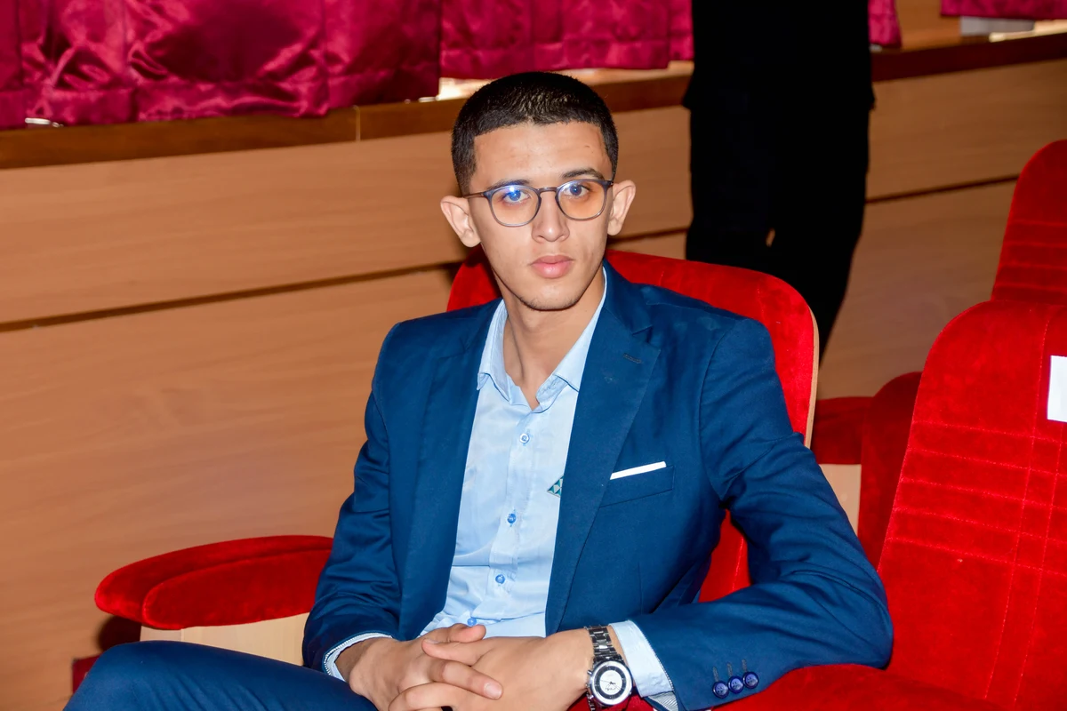 Abdellah El Bouchouari seated in an auditorium
